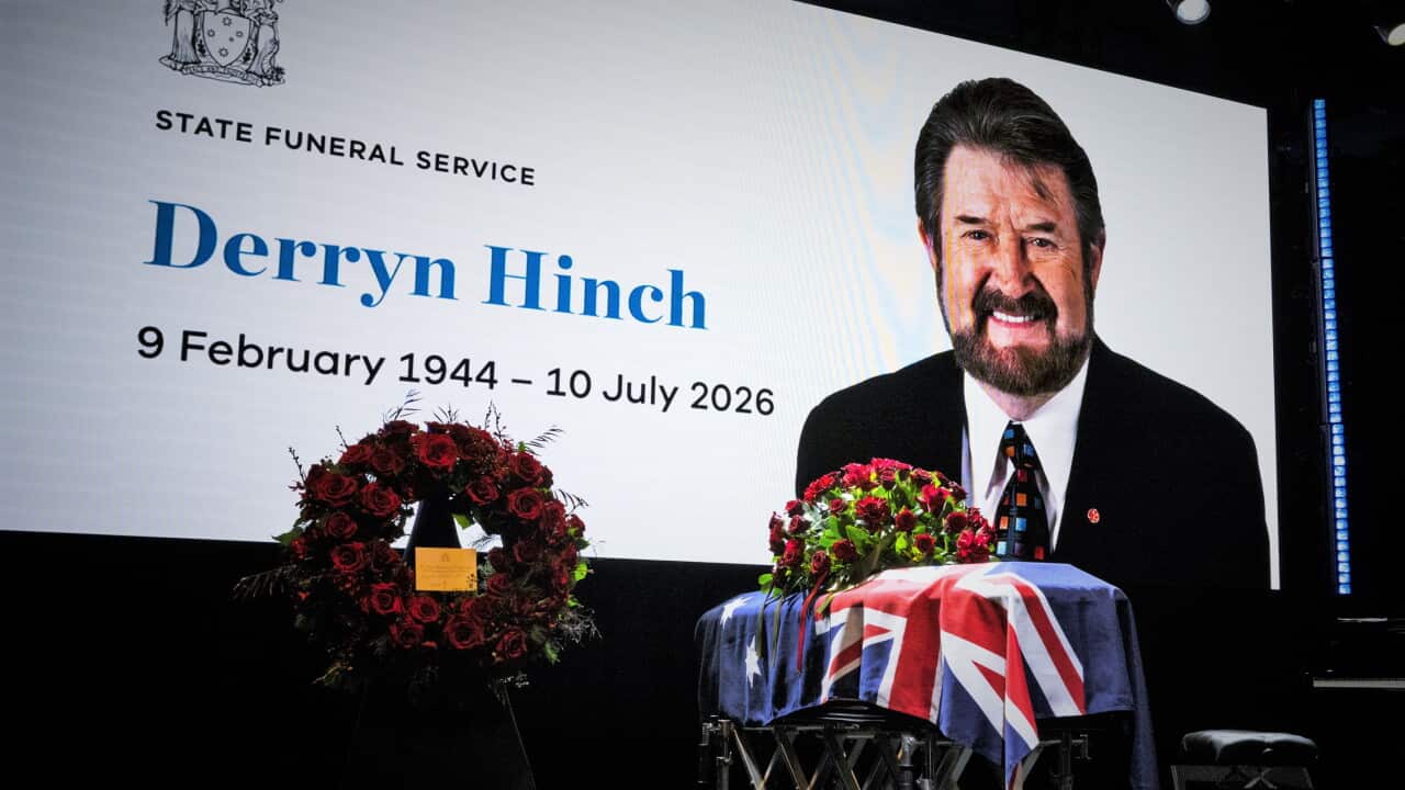 A coffin on a stage, draped in an Australian flag, next to a wreath. A screen shows Derryn Hinch and the words "State Funeral Service: Derryn Hinch. 9 February 1944 - 10 July 2026".