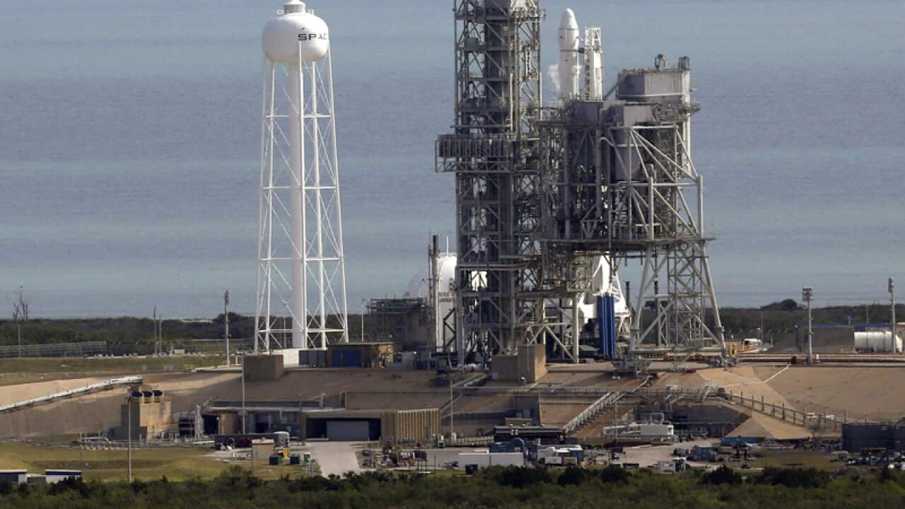 A Space X Falcon9 rocket sits on the launch pad
