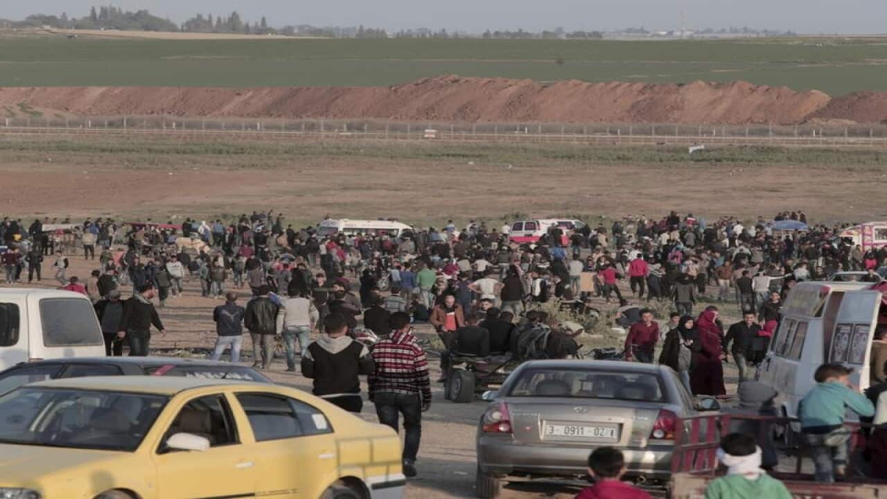 Palestinian protesters gather near the Gaza Strip border with Israel