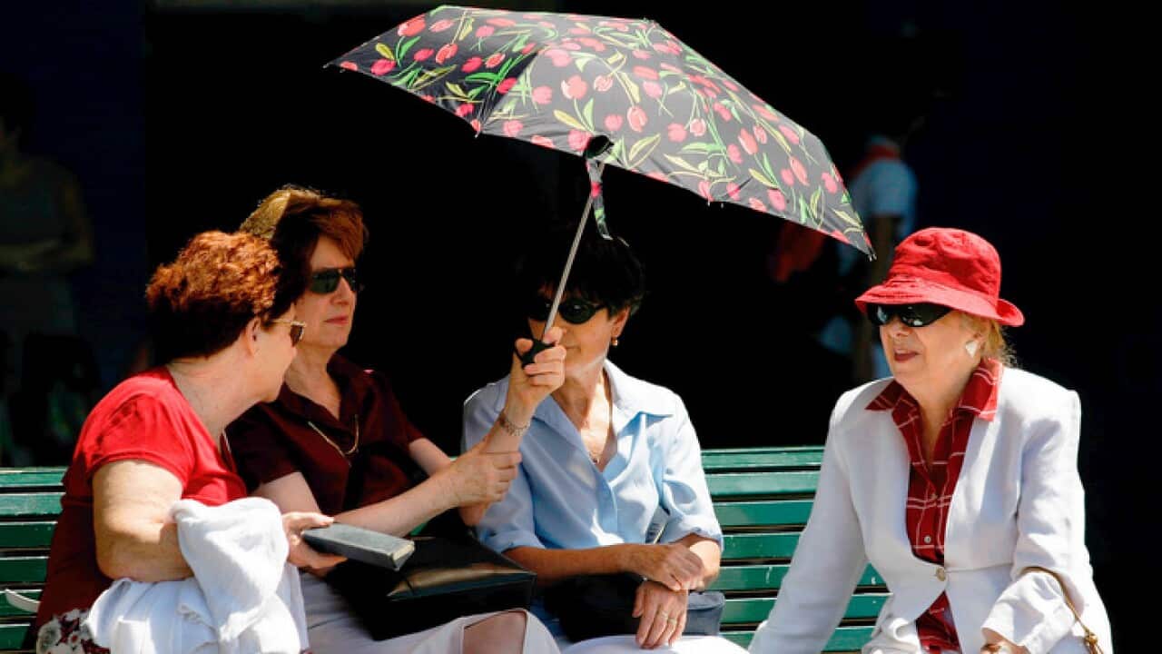 Women seek refuge from the heat at Circular Quay in Sydney
