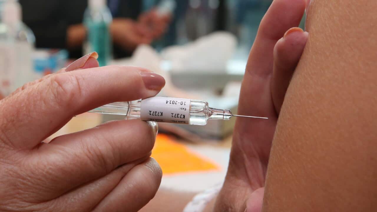Health care workers receive the flu vaccination
