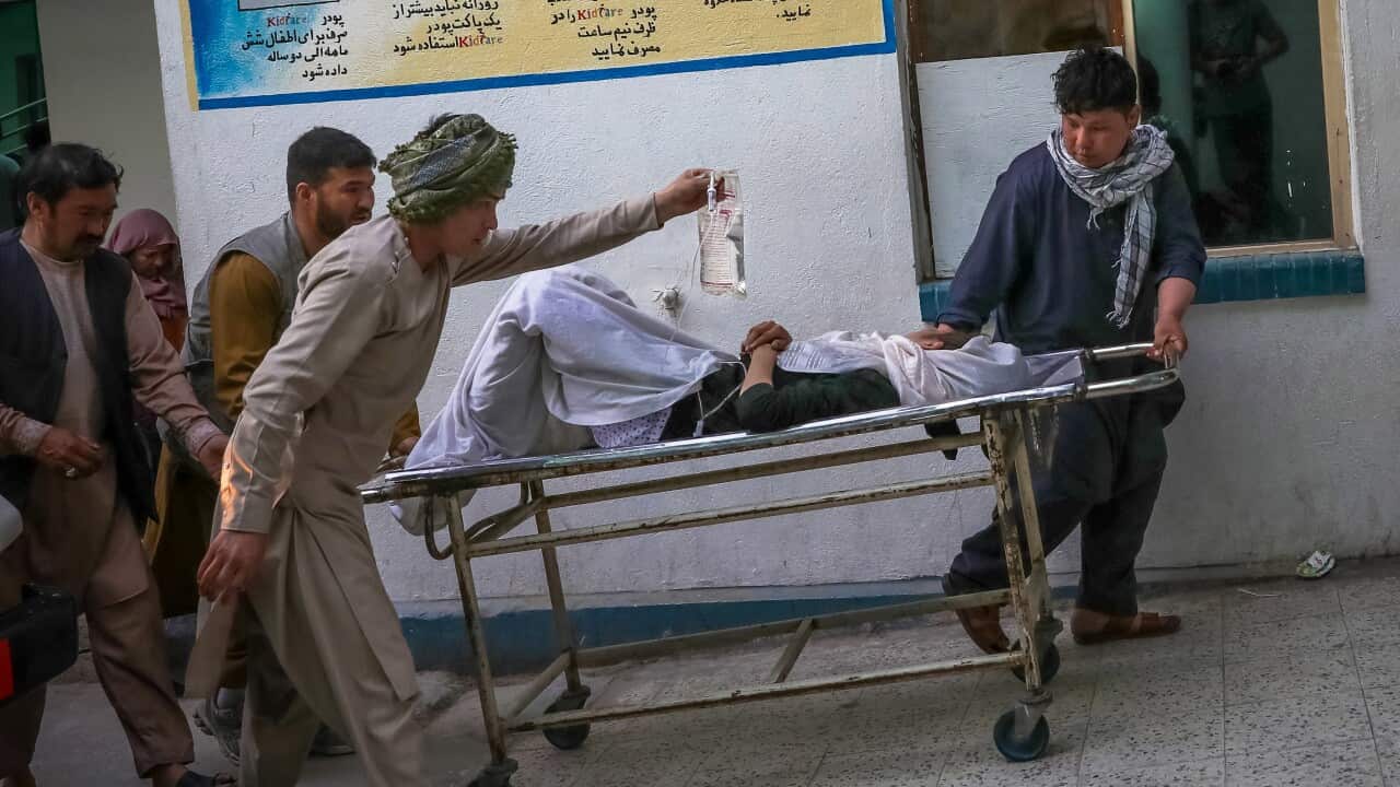 People carry an injured girl into a hospital after an explosion in downtown Kabul, Afghanistan, 8 May 2021.