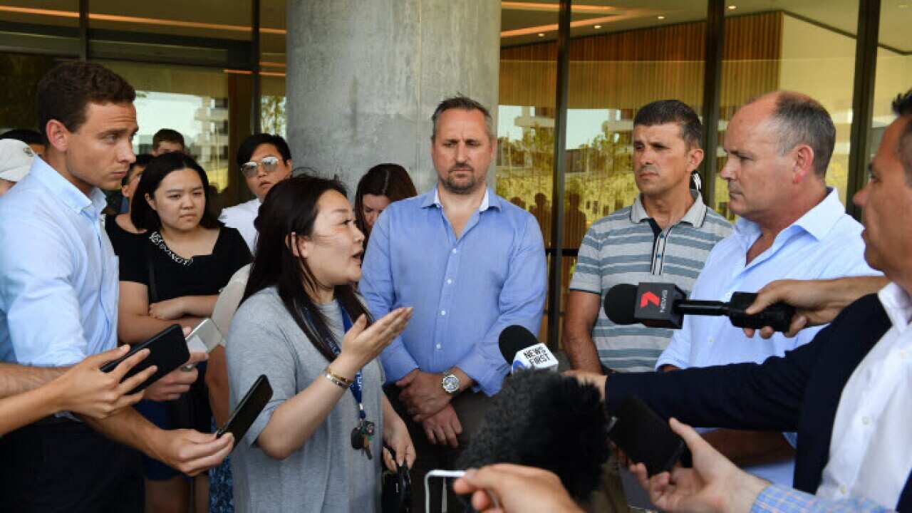 A frustrated resident asks questions of Icon Managing Director Julian Doyle