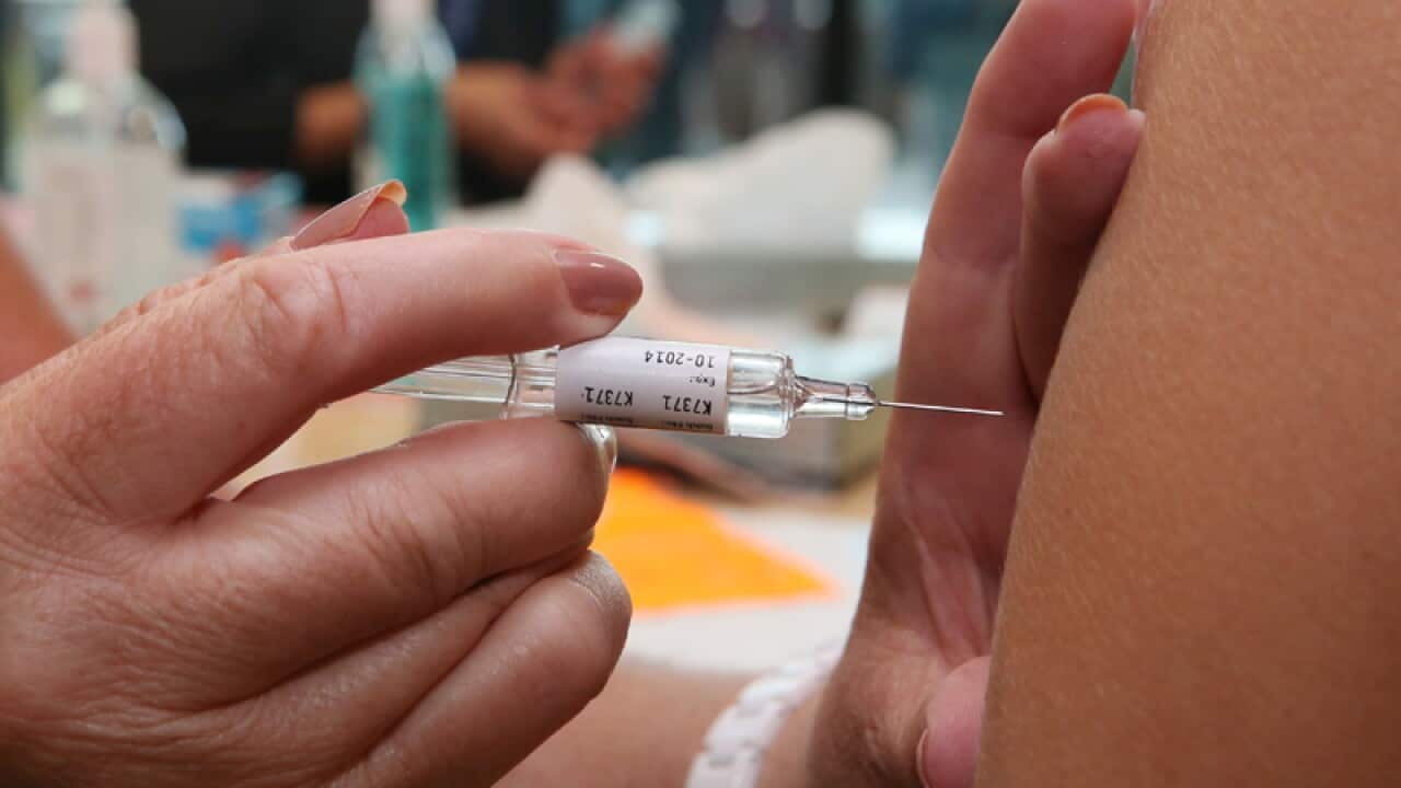 Health care workers receive a flu vaccination
