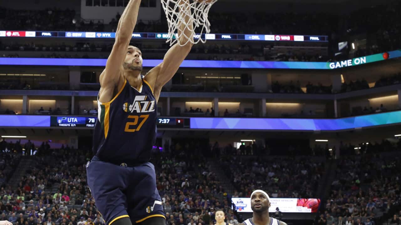 Utah Jazz center Rudy Gobert, left, as Kings guard Ty Lawson looks on