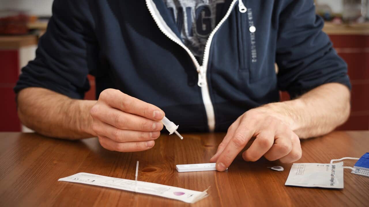 Man conducts a rapid antigen test at home