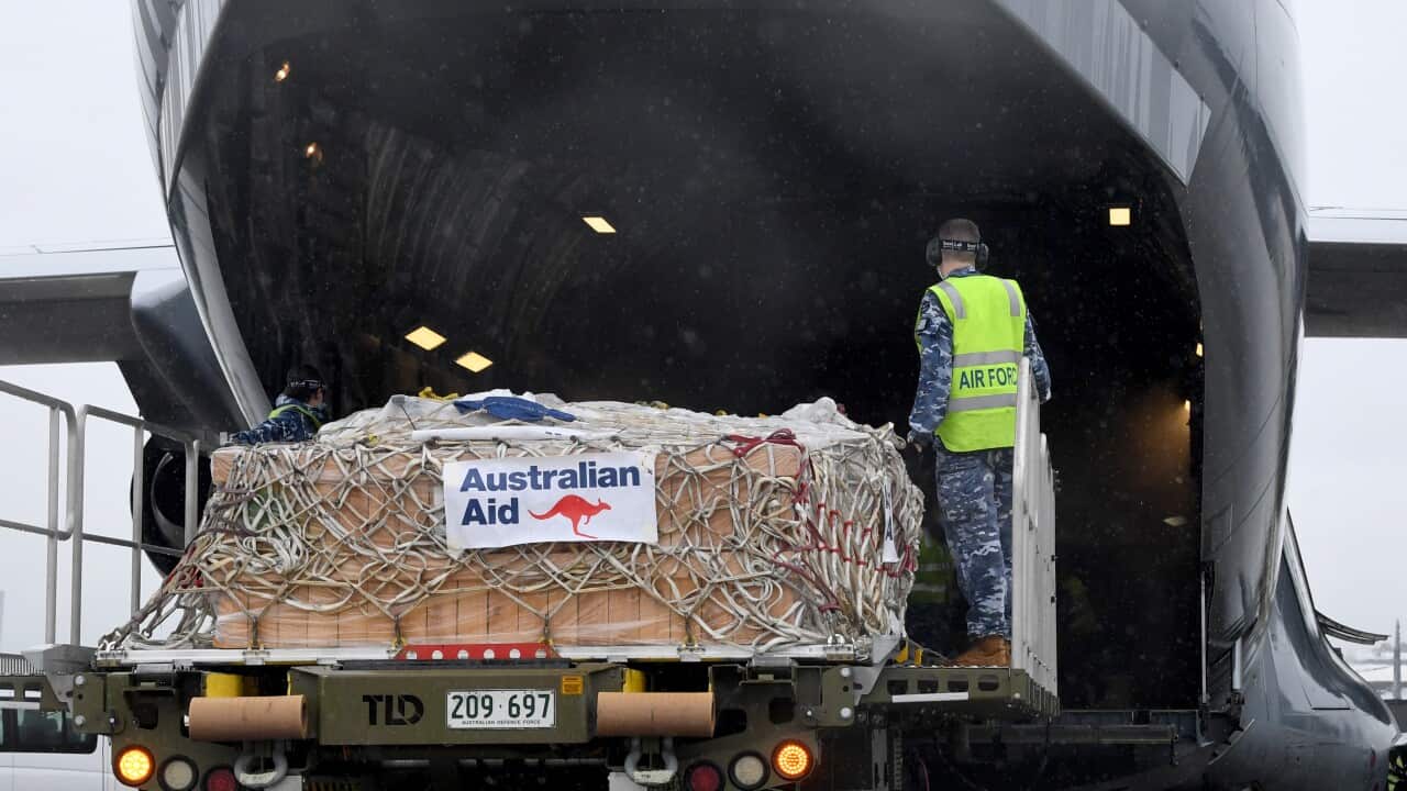 A Royal Australian Air Force member loads COVID-19 vaccines at RAAF Base Amberley, west of Brisbane, ahead of their arrival in PNG