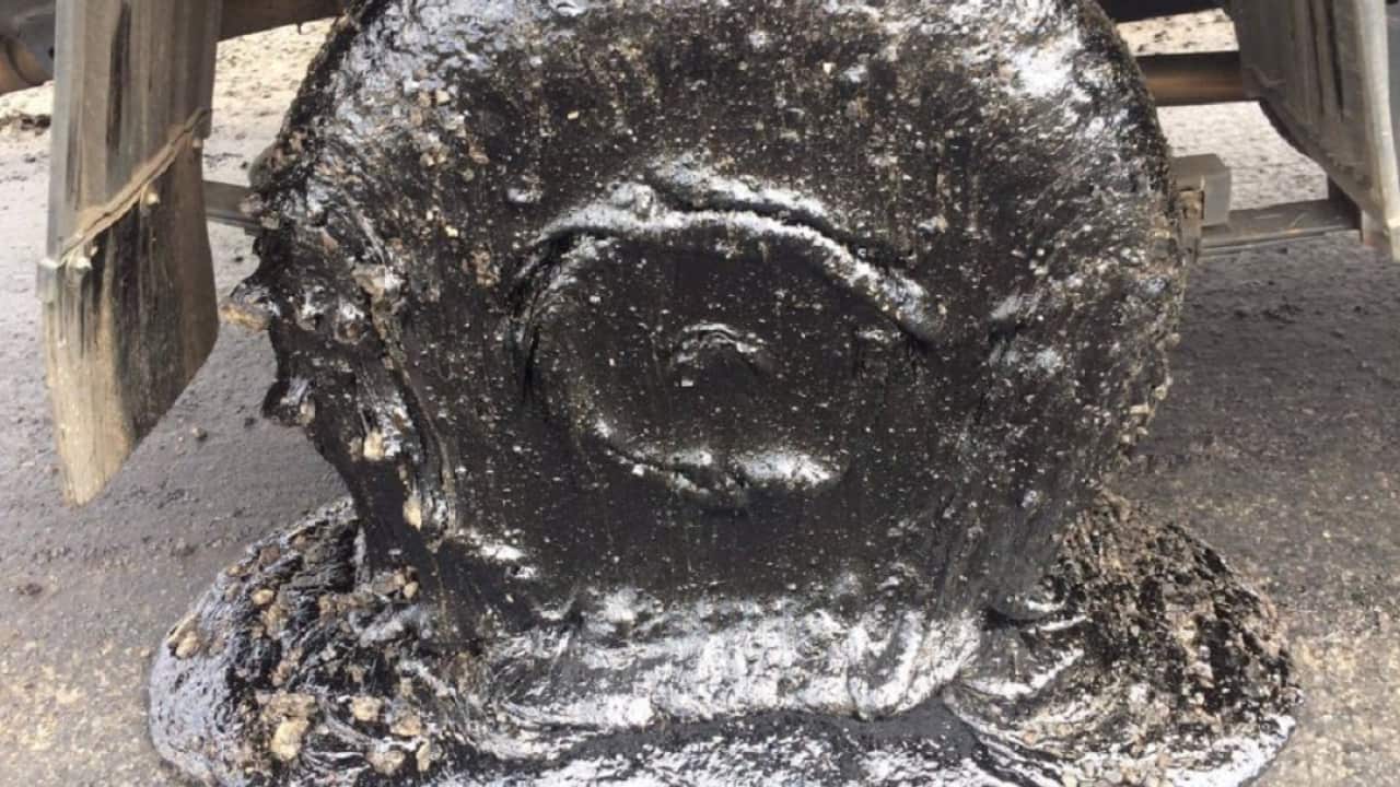 A tyre coated in bitumen.