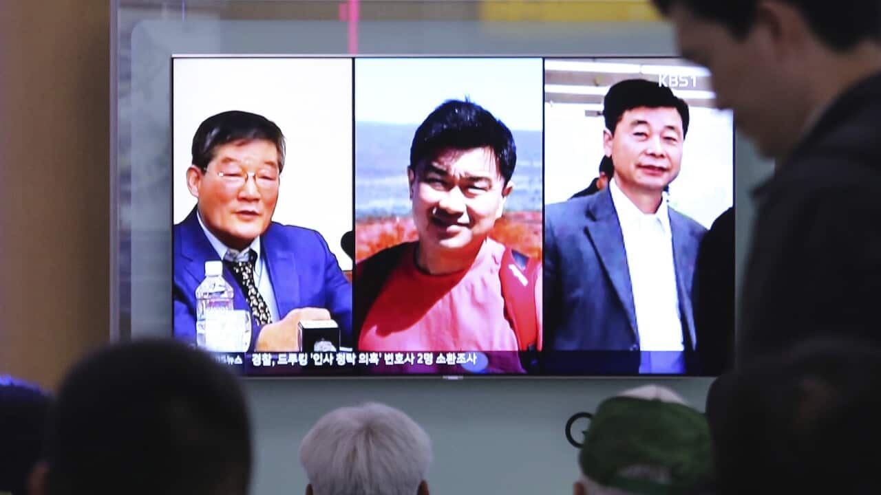 People watch a TV news report on screen, showing portraits of three Americans, Kim Dong Chul, left, Tony Kim and Kim Hak Song, right, detained in the North Korea.