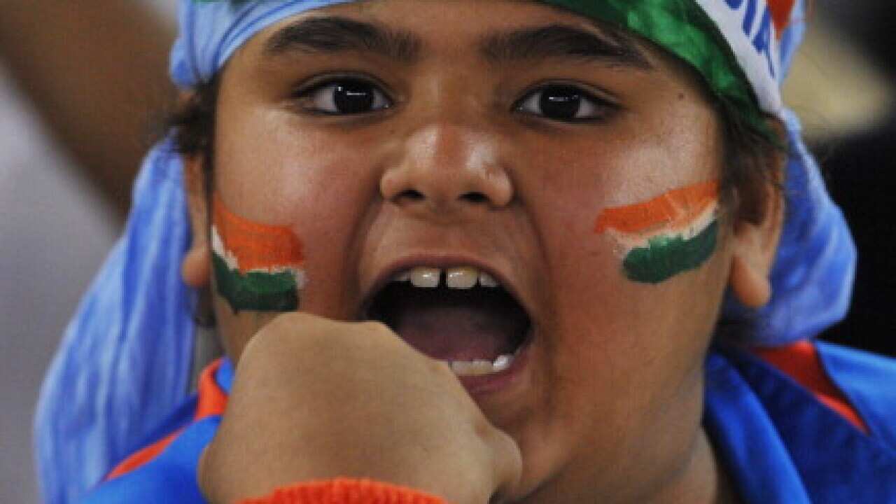 An Indian cricket supporter cheers his t