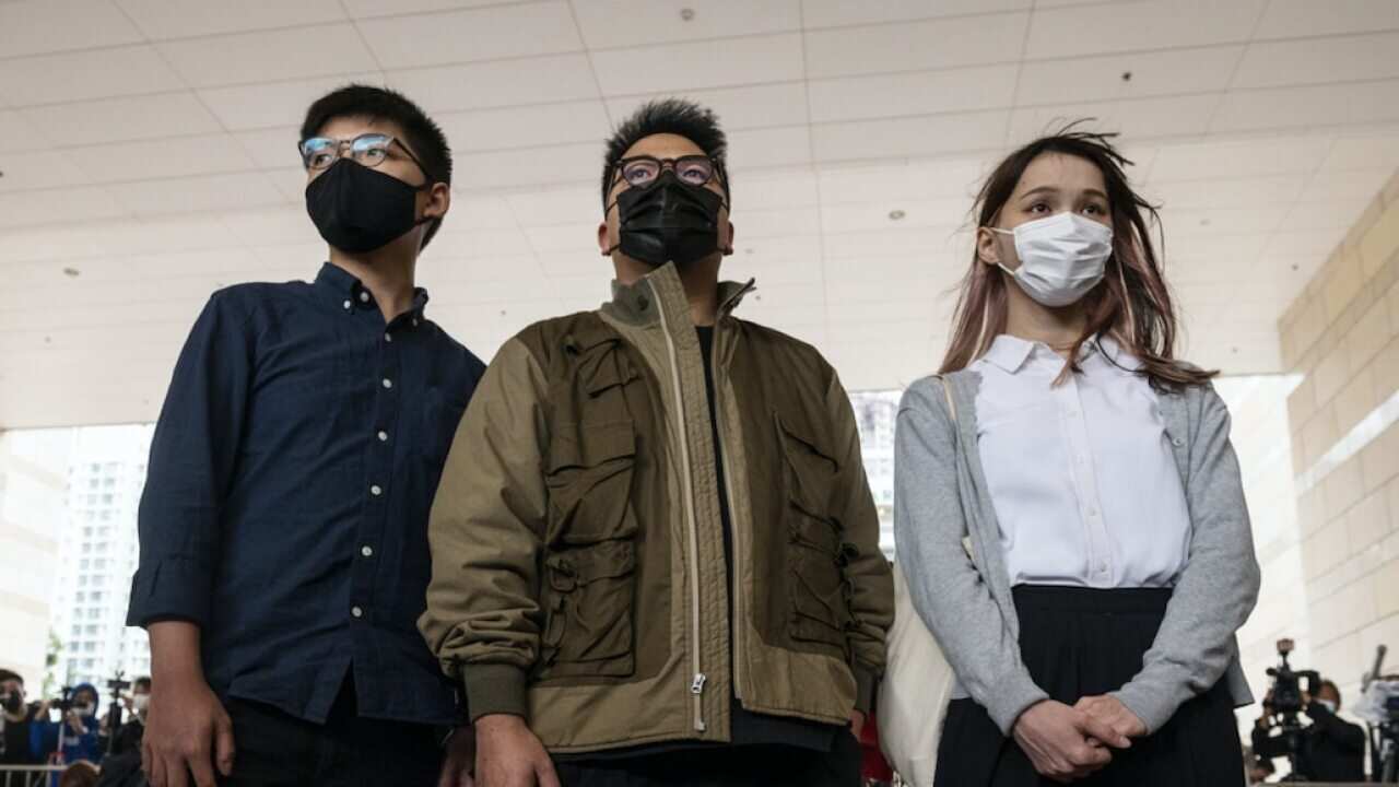 Joshua Wong (L), Ivan Lam (C), and Agnes Chow (R) arrive at the West Kowloon Law Courts building last month