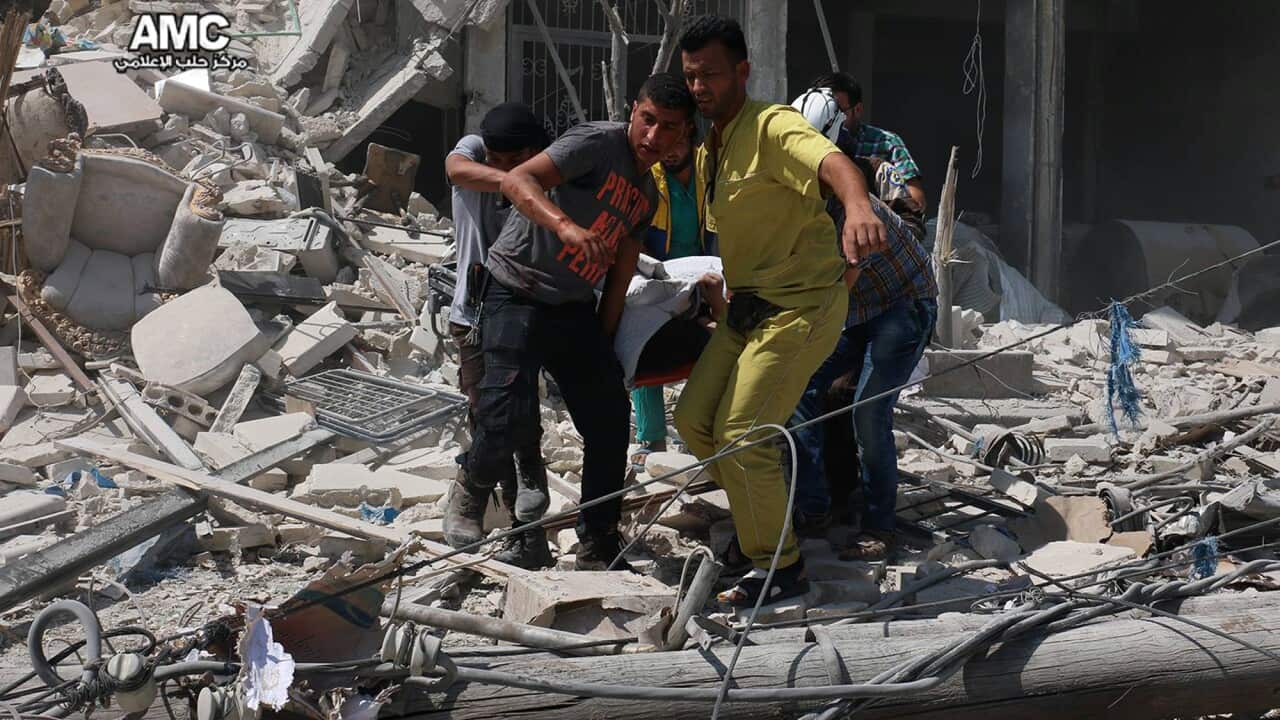 Syrians carrying a victim after barrel bombs were dropped on the Bab al-Nairab neighborhood in Aleppo, Syria, Saturday, Aug. 27, 2016.