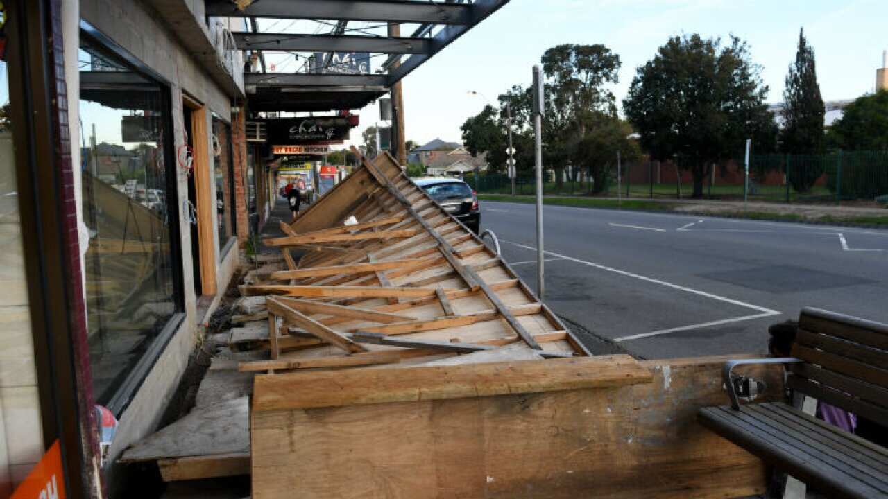 A wooden wall at a construction site is blown over in high winds on Buckley St, Essendon in Melbourne,