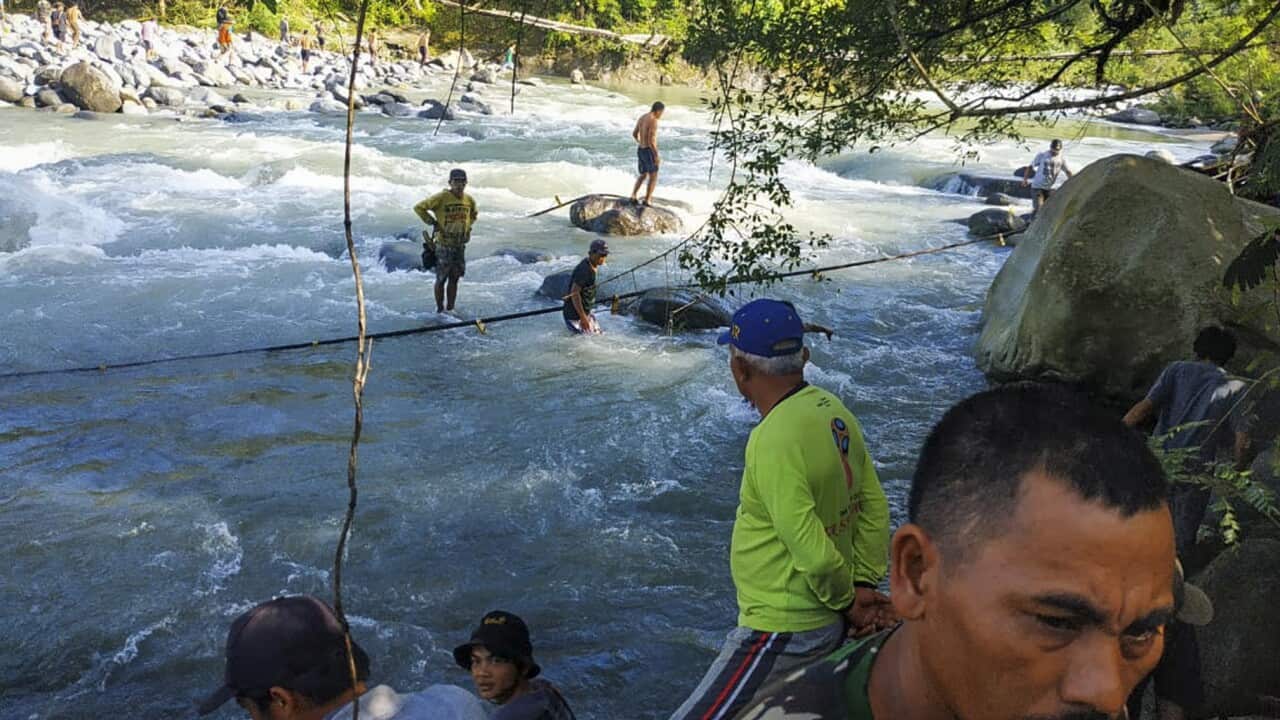 Rescuers and residents search for victims after a footbridge collapsed