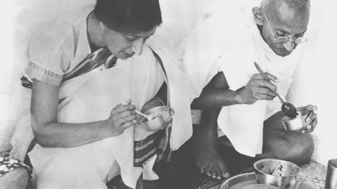 Mahatma Gandhi, right, sits down to share a meal with a guest in his home in India on May 22, 1936. (AP Photo)