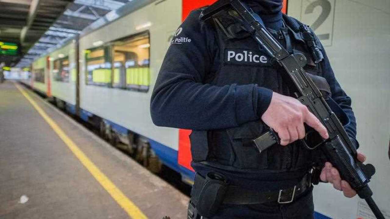 An armed Belgian police officer patrols at Midi train station in Brussels, Belgium.