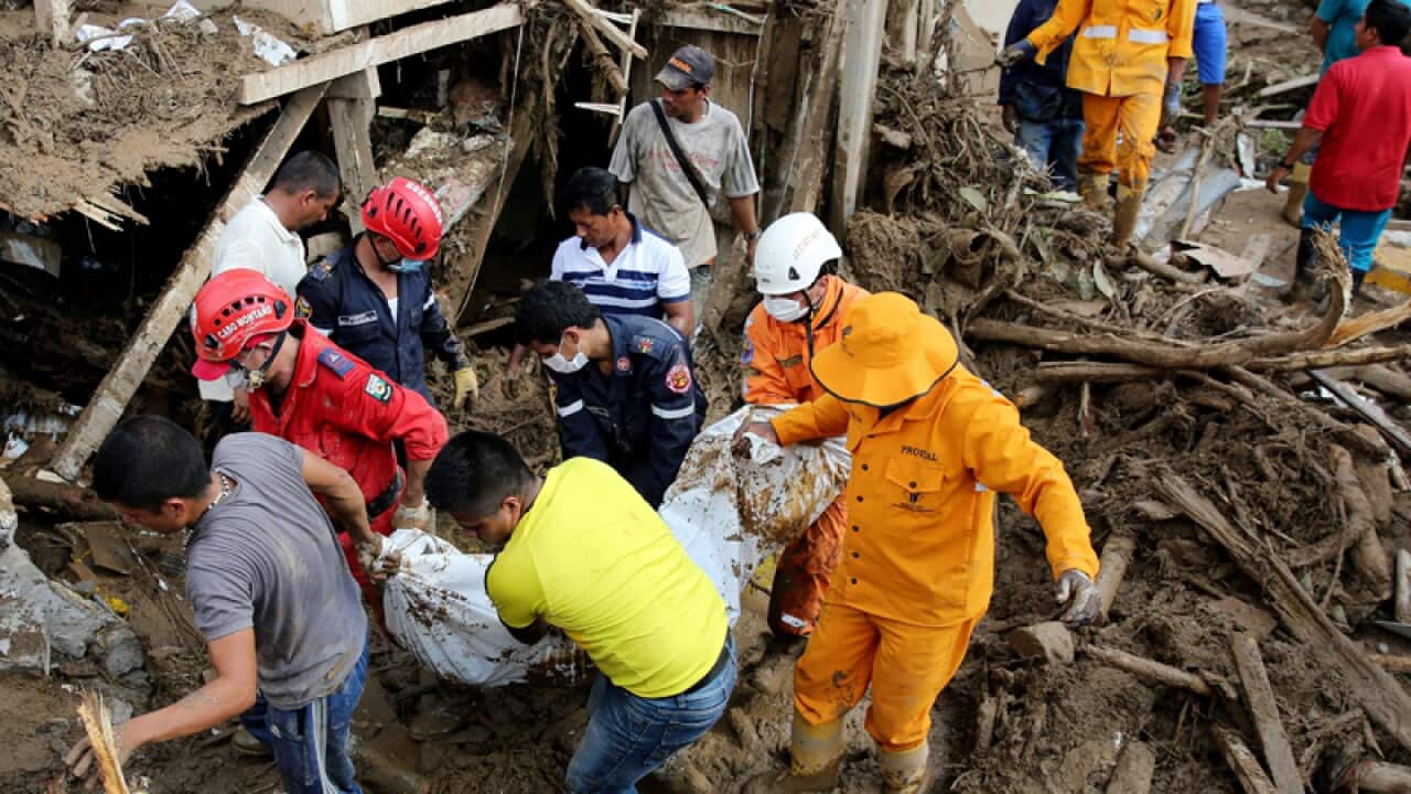 Emergency teams recover the body of a woman in Mocoa