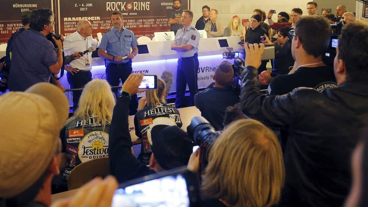 The CEO of Live Nation GSA Marek Lieberberg and police officers give a statement after the evacuation of the Rock am Ring festival in Germany.