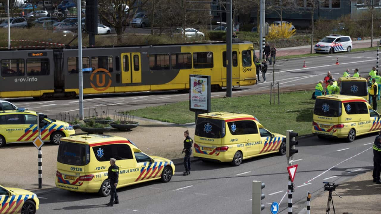 Ambulances are parked next to a tram after a shooting incident in Utrecht, Netherlands.