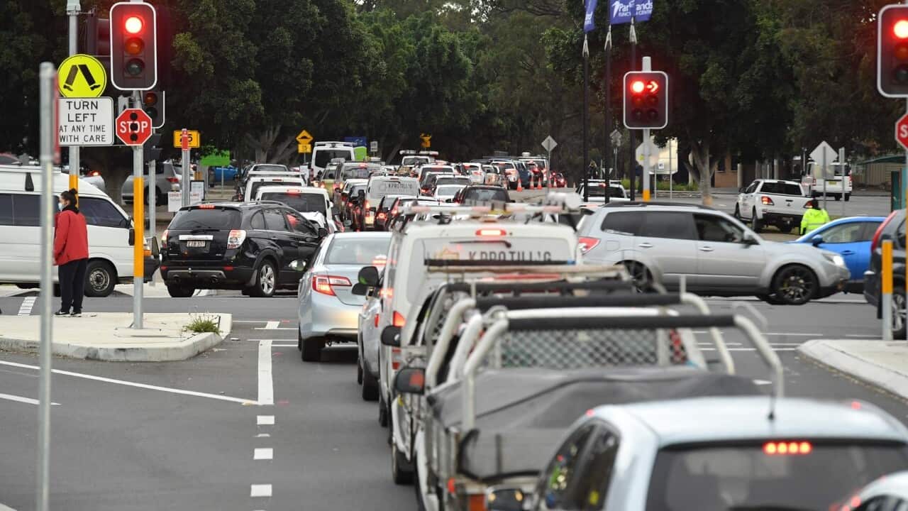 Long queues of cars are seen at a pop up Covid testing clinic at the Fairfield Showgrounds in Sydney (AAP)