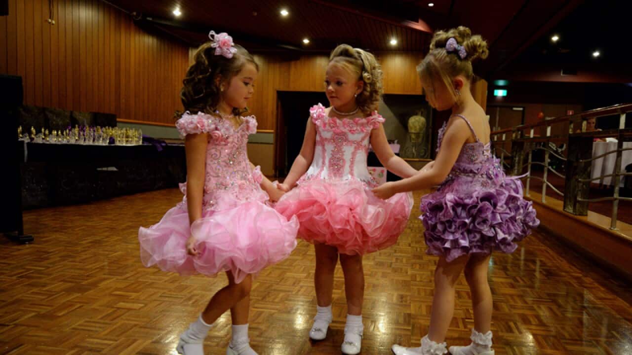 Little girls get ready for a child pageant.