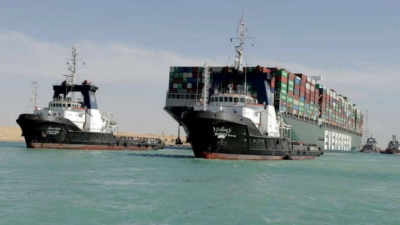 Tugboats near the Ever Given container ship after it was refloated in the Suez Canal, Egypt, 29 March 2021.