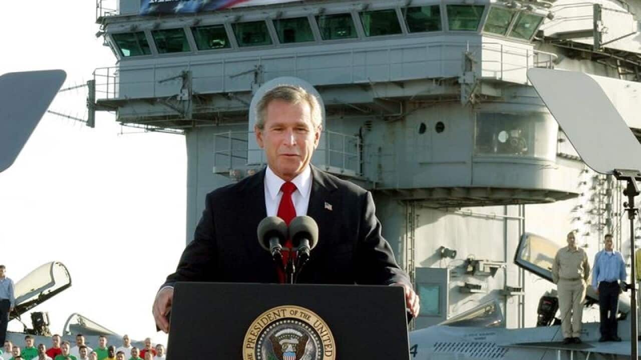 A file image of President George W. Bush and the infamous banner