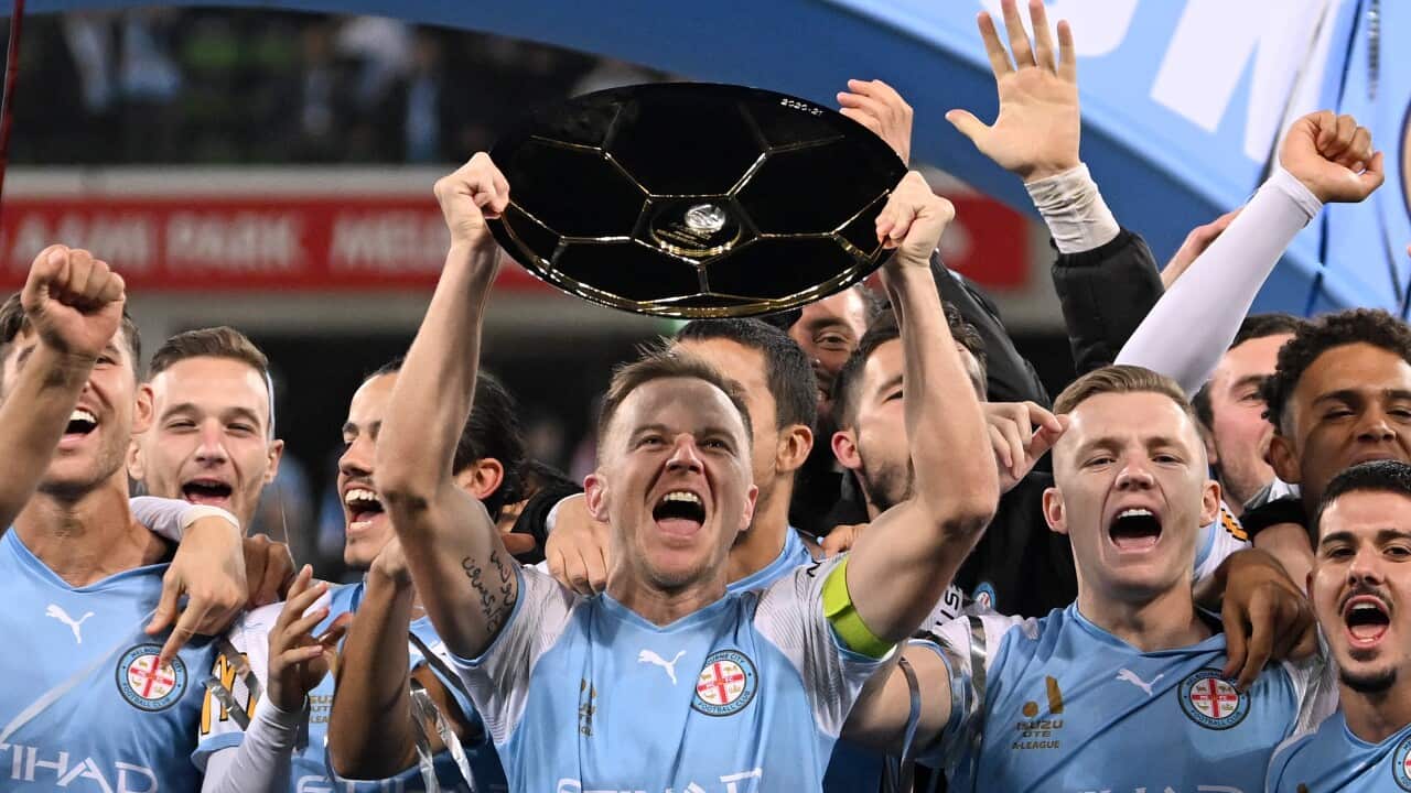 Scott Jamieson of Melbourne City holds up the A-league Premiers Plate.