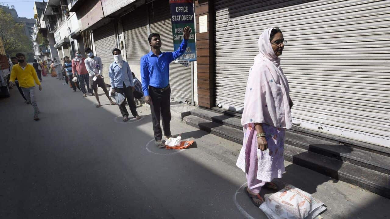 People shop for essentials during India's three-week lockdown