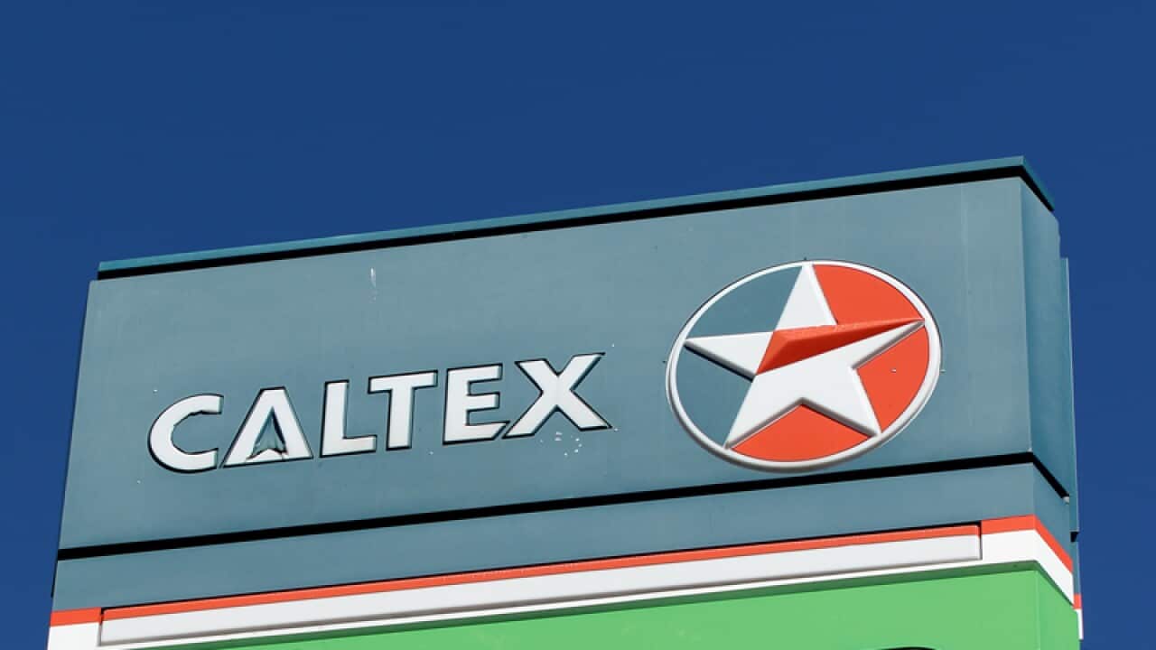 Signage displayed at a Woolworths service station.