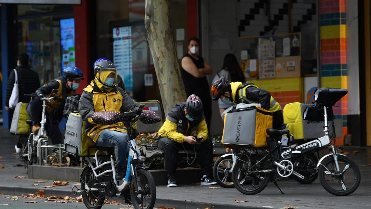 Delivery drivers are seen in Melbourne, Tuesday, June 1, 2021. Victoria has recorded three new additional cases of coronavirus in the past 24 hours. (AAP Image/James Ross) NO ARCHIVING