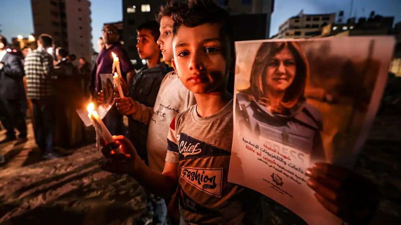 Children take part in a candlelight vigil to condemn the killing of veteran Al-Jazeera journalist Shireen Abu Akleh, in Gaza City, on 11 May 11, 2022.