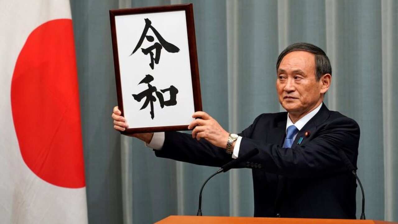 Japan's Chief Cabinet Secretary Yoshihide Suga unveils 'Reiwa' as the new era name at the prime minister's office in Tokyo, Japan, 01 April 2019.