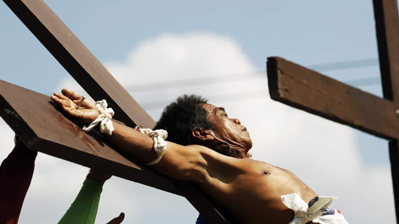 A Filipino penitent is nailed to a wooden cross.