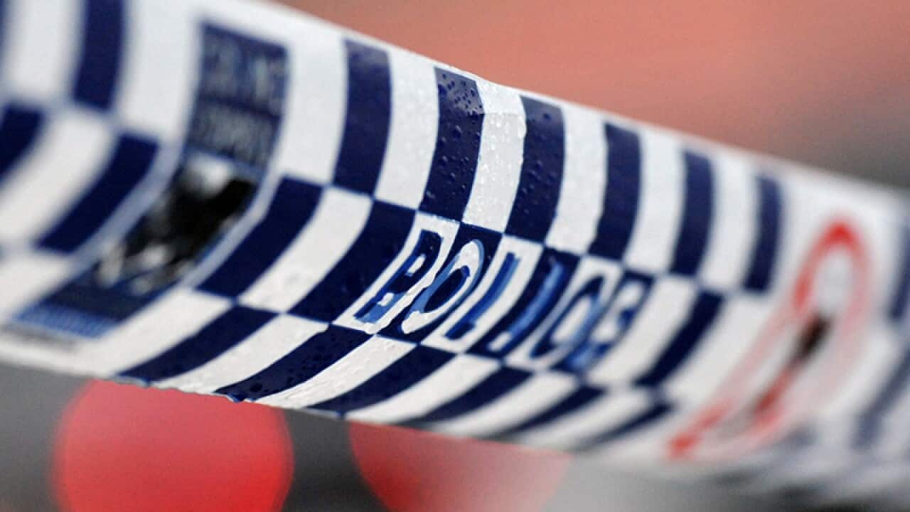 Police tape restricts access to a crime scene