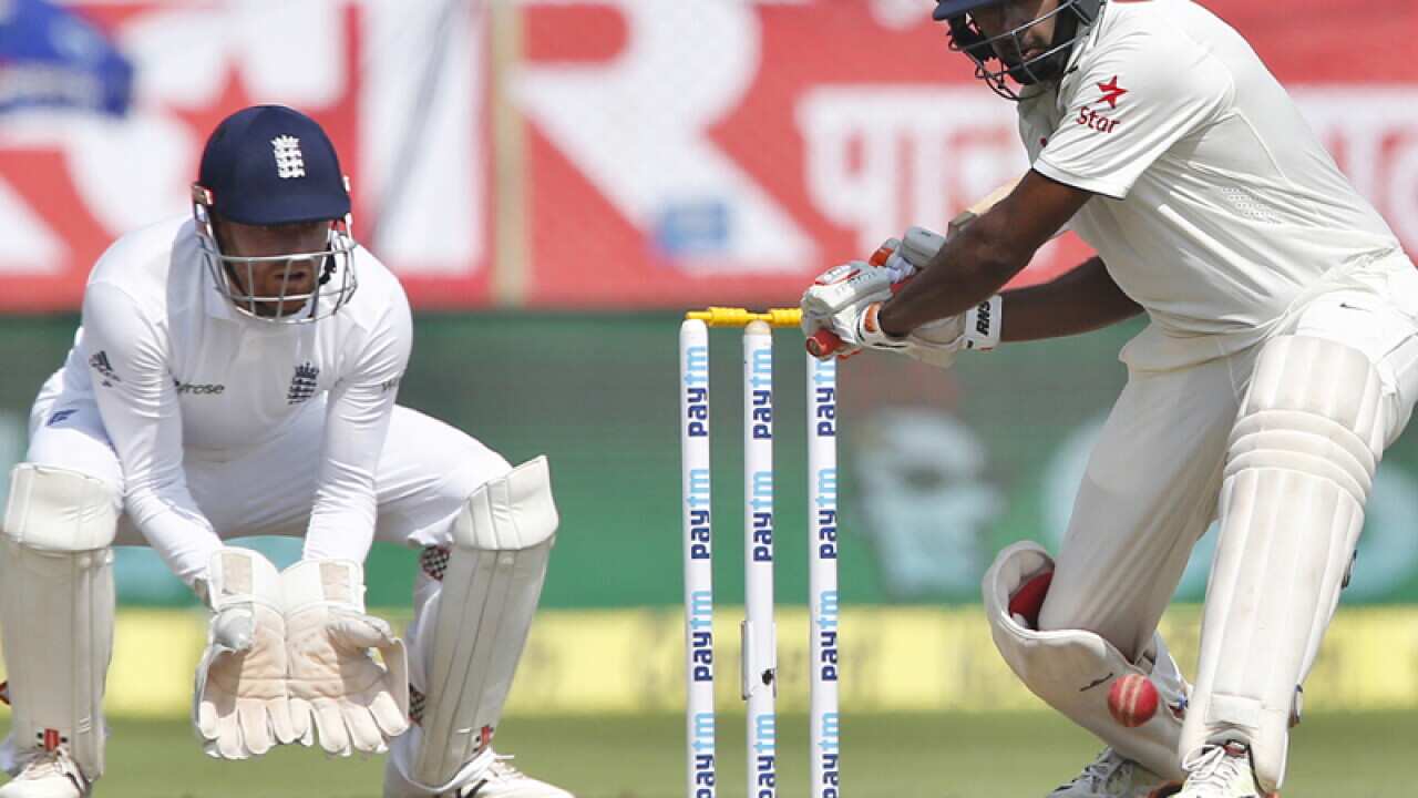 India's Ravichandran Ashwin (R) prepares to play a shot
