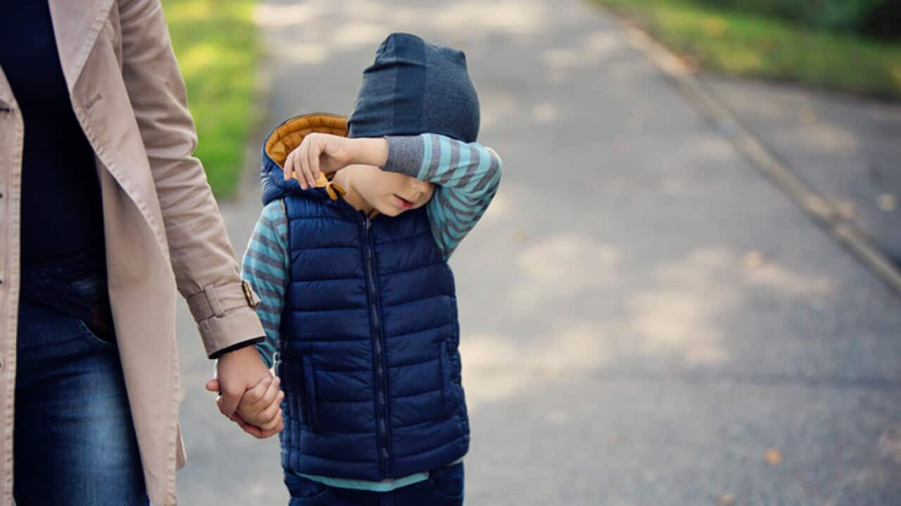 mother holding her son's hand