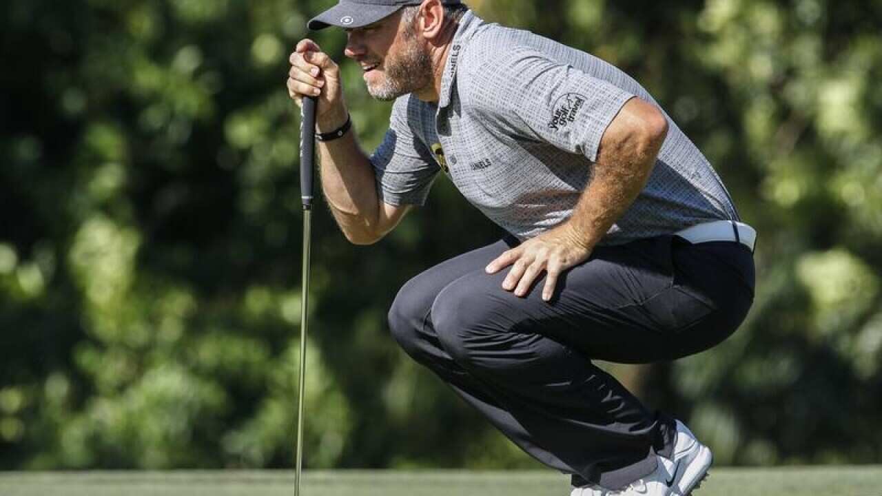 Lee Westwood of England aligns his putt.