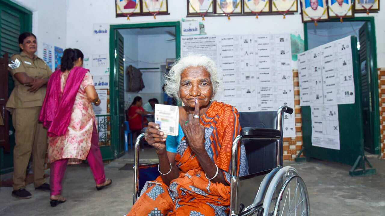 Chennai: An elderly woman voter showing mark of indelible ink