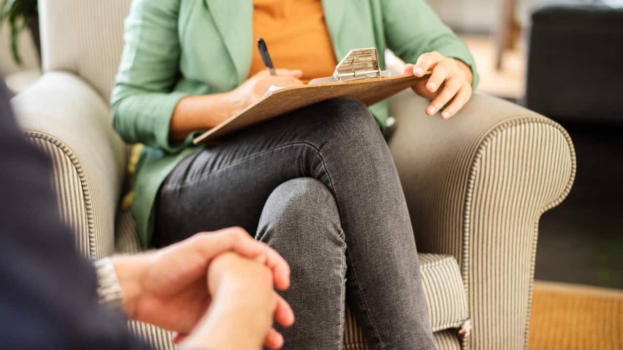Mental health professional taking notes during a counseling session