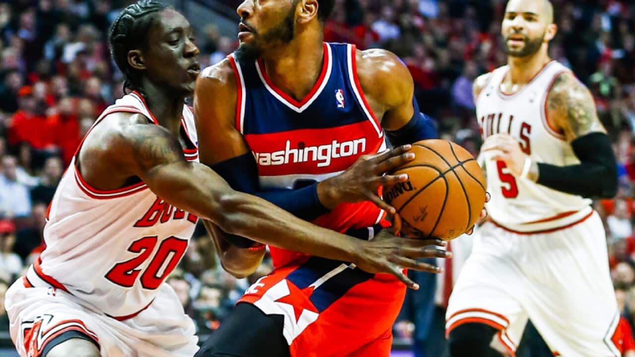 Washington Wizards guard John Wall (R) drives to the basket