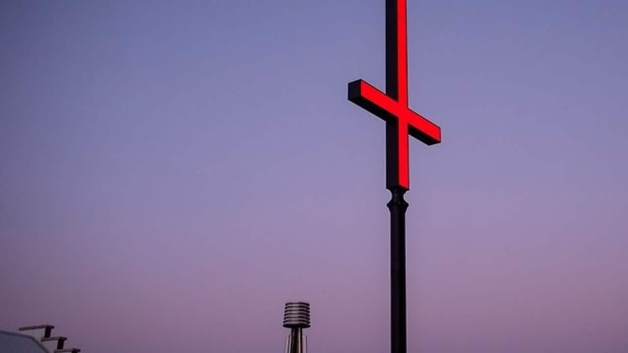 A giant red inverted crosses installed at the Hobart waterfront as part of the annual Dark Mofo festival, 8 Jun 2018.