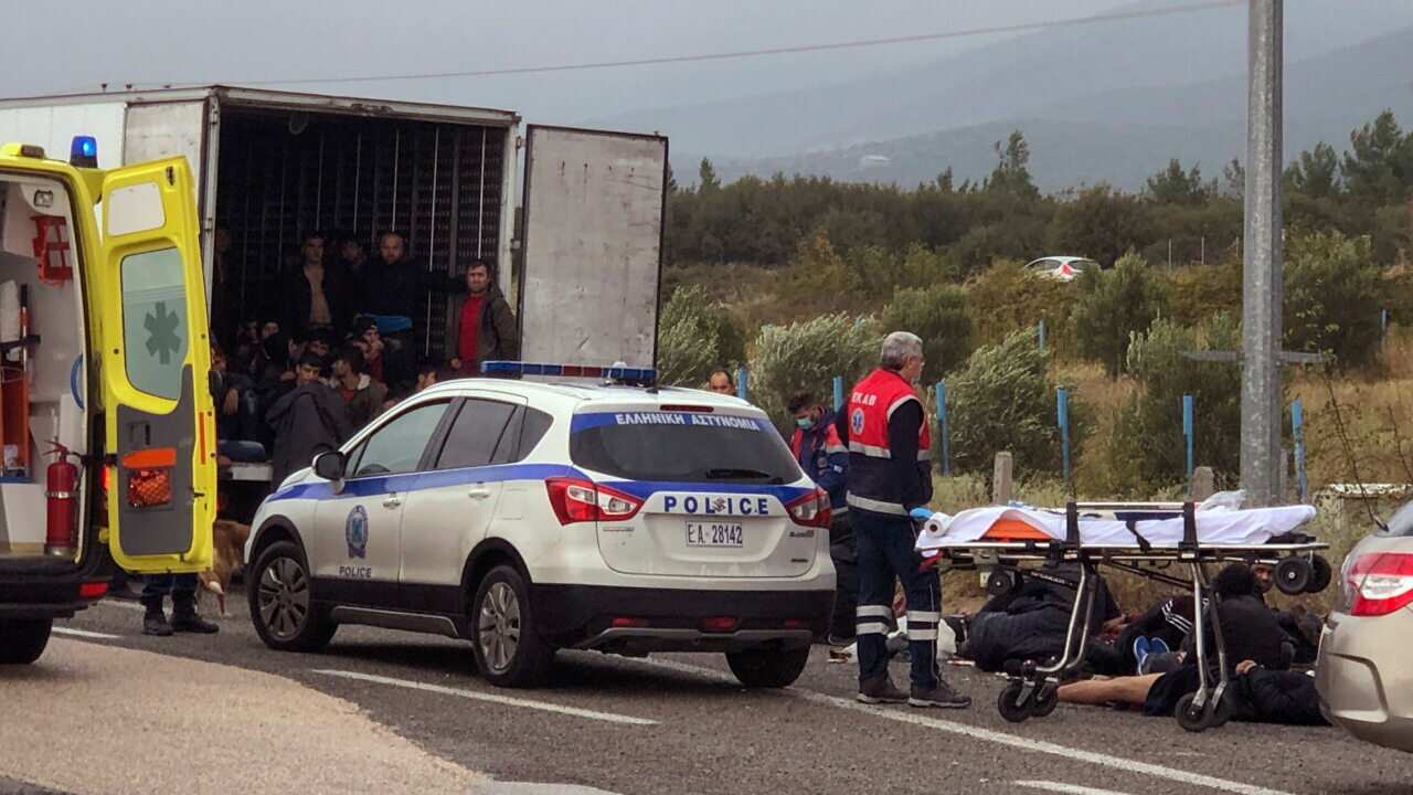 Migrants are seen inside a truck found by police, as ambulance stuff arrive to the scene near the town of Xanthi, on Monday, Nov. 4, 2019.