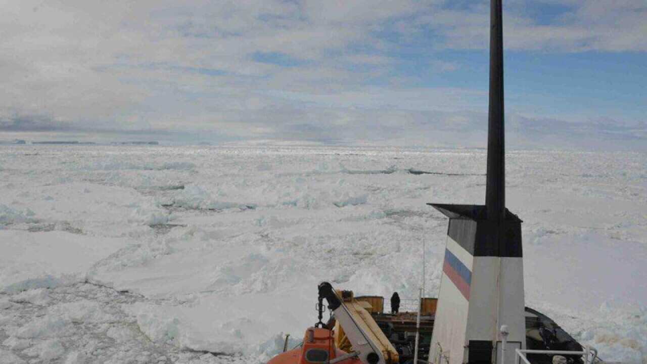 An Antarctic-bound cruise liner wedged in thick sheets of sea ice