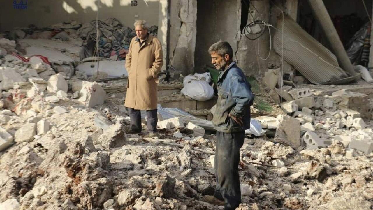 Locals inspect the damage after an air strike