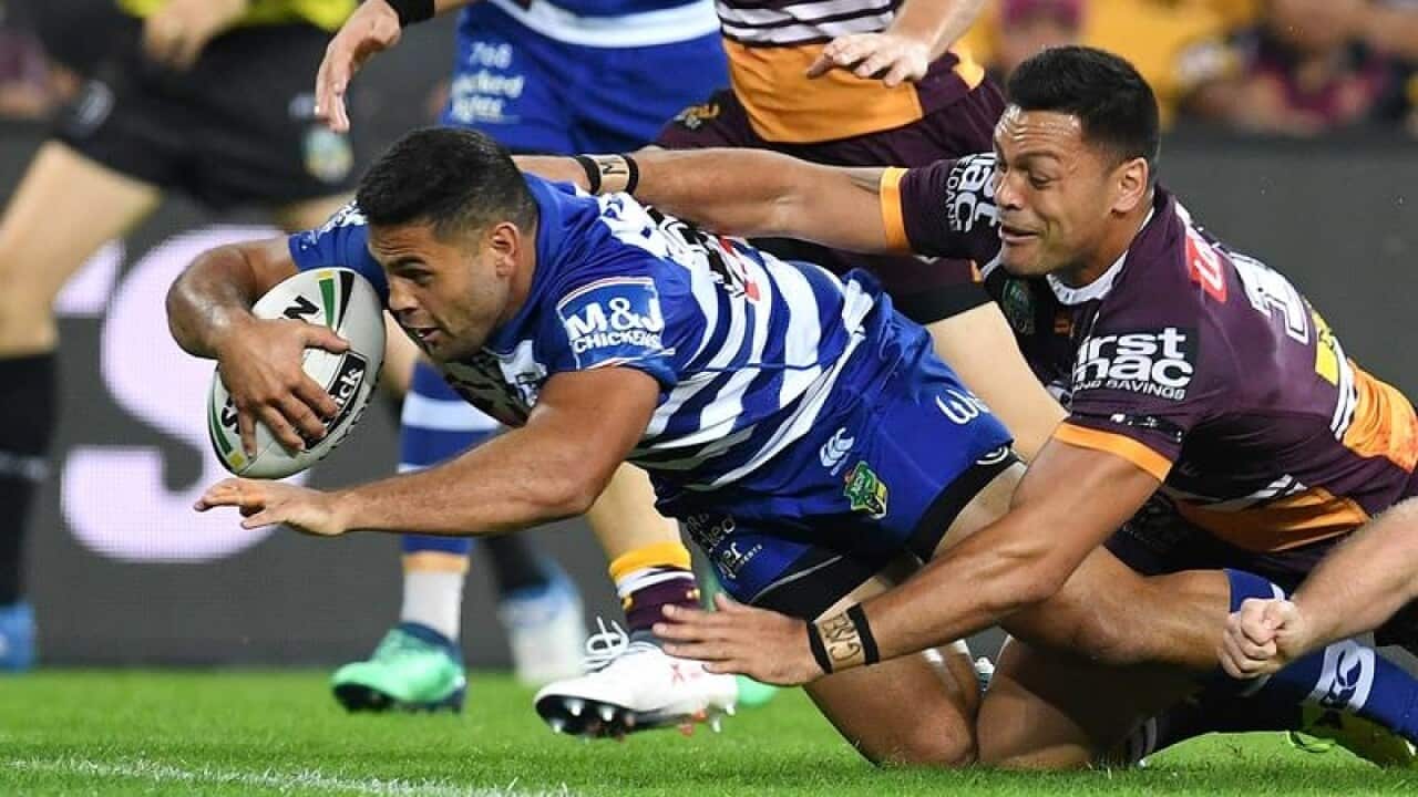 Rhyse Martin of the Bulldogs (left) scores a try during round 9.