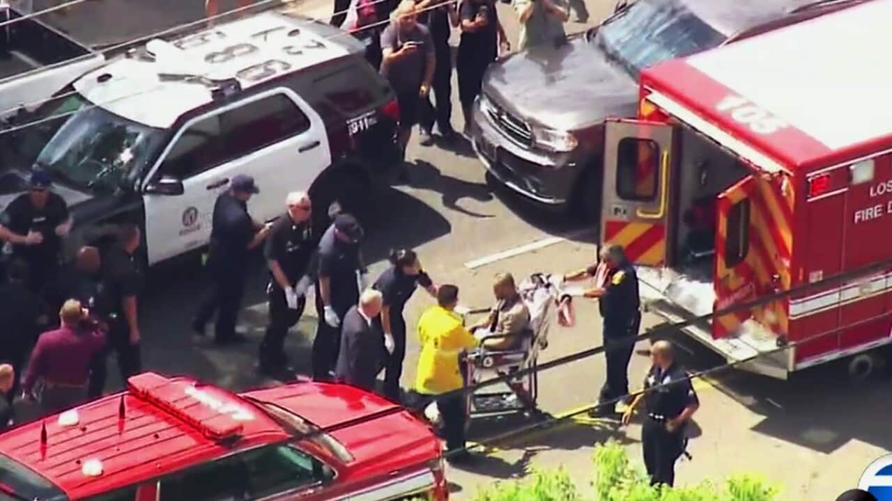 Gerry Dean Zaragoza, 26, a suspect in a 12-hour rempage in Los Angeles' San Fernando Valley, being wheeled to an ambulance.