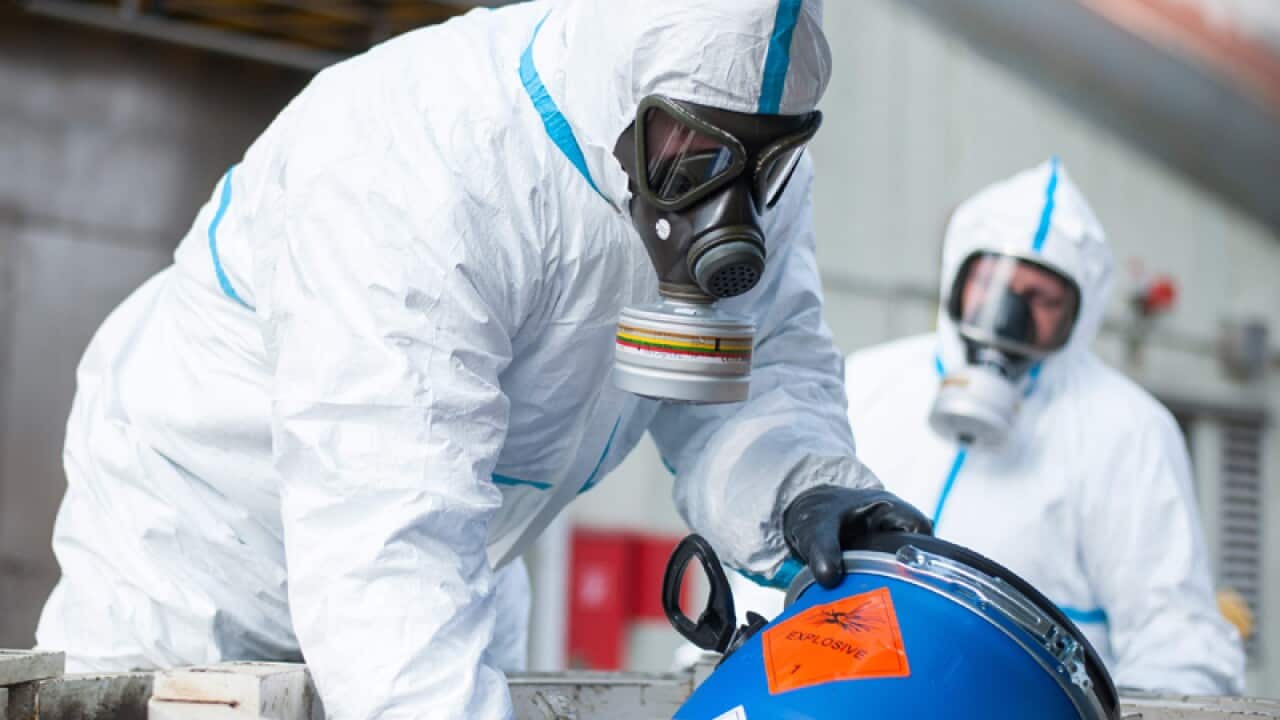 Two chemical weapons disposers during a demonstration