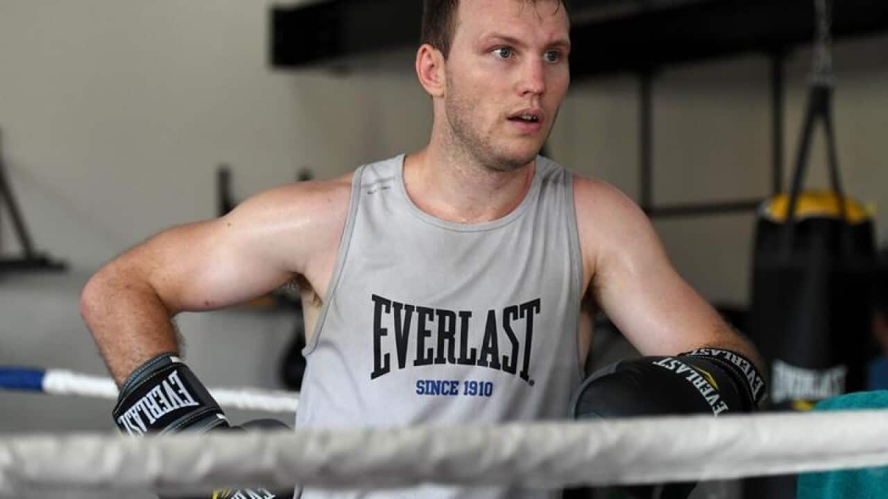 Australian boxer Jeff Horn rests between training