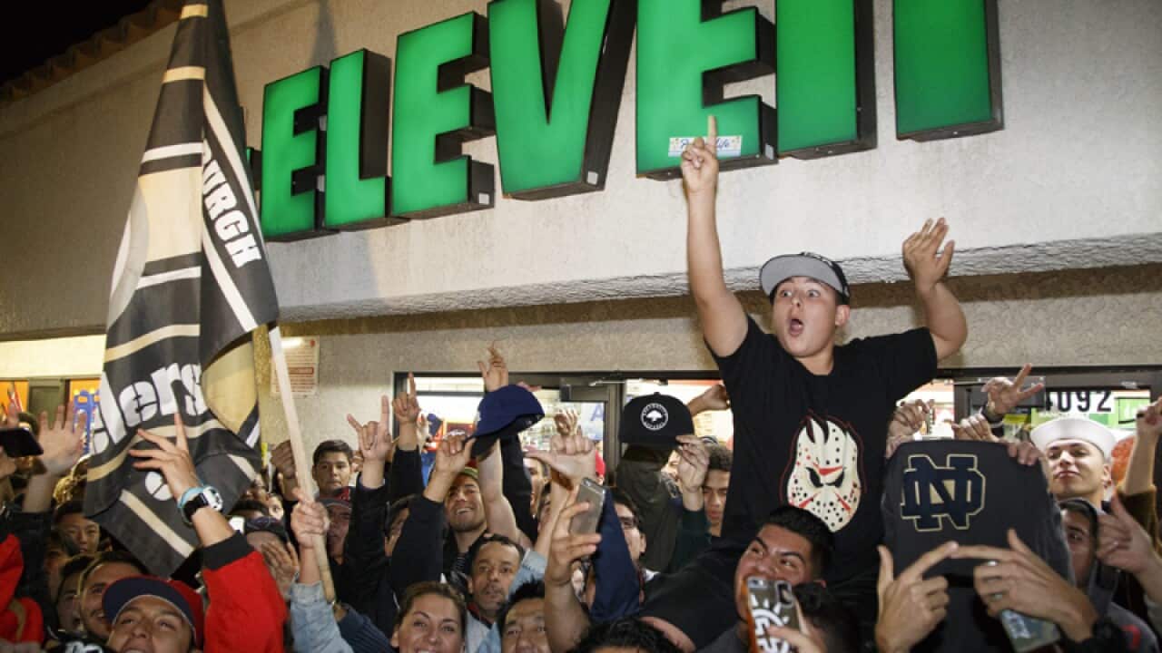 People outside the 7-Eleven store where a winning ticket was purchased